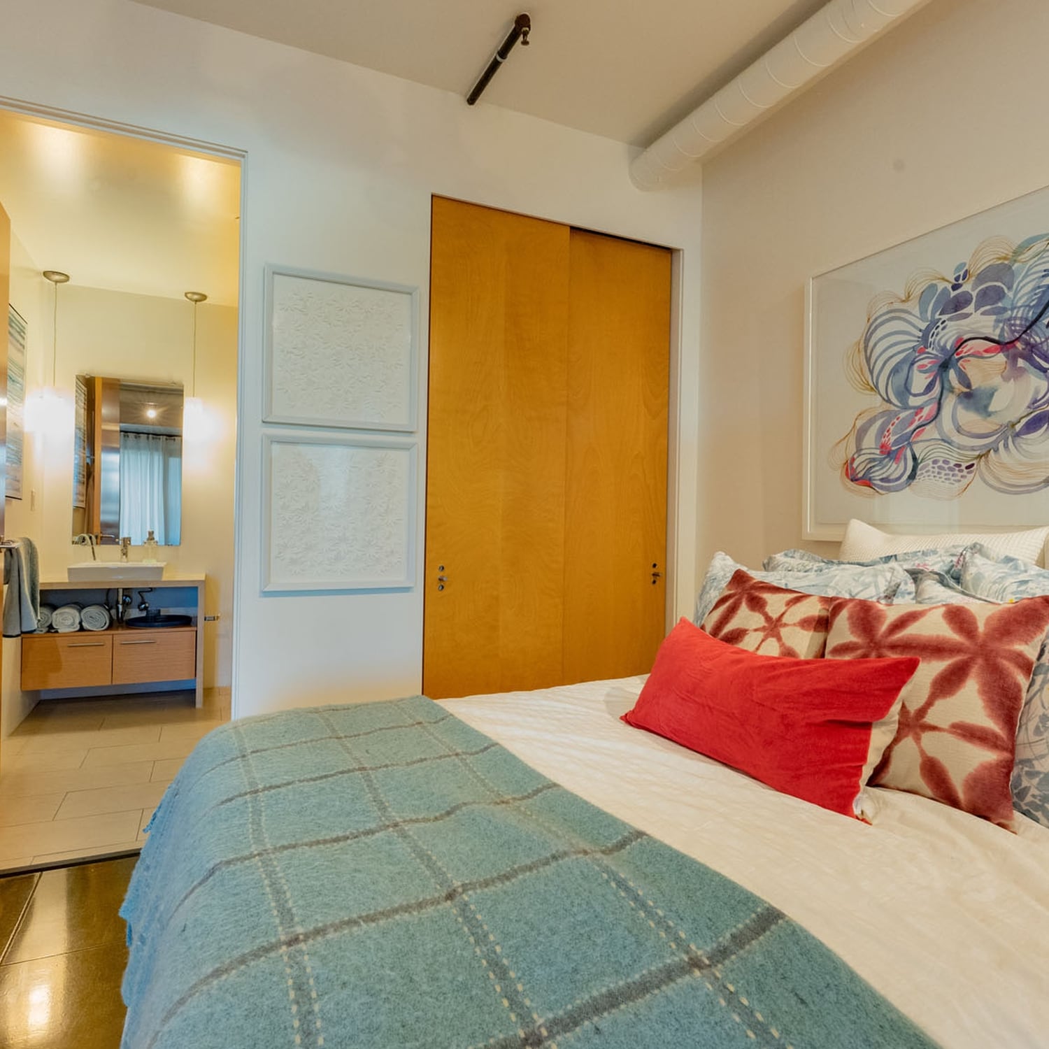 Apartments in Dogpatch-Spacious Master Bedroom With Dark Hardwood Floors, Master Bathroom, and Sliding Closet Doors